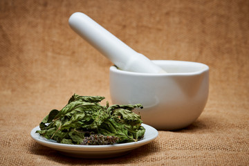 Mint leaves on background mortar with pestle.