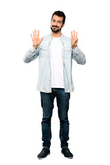 Full-length shot of Handsome man with beard counting eight with fingers over isolated white background