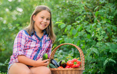 Hungry. happy little farmer. autumn harvest. little girl vegetable in basket. Only natural. harvest vitamin. spring market garden. kid on summer farm. Organic food. healthy food for children