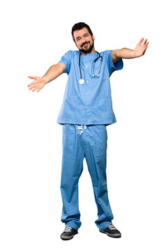Full-length shot of Surgeon doctor man presenting and inviting to come with hand over isolated white background