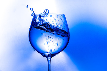  splash of water from a wine glass on a light background