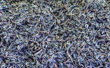 black dried tea leaves background