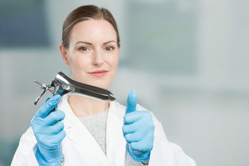 Female gynecologist with a speculum in her hand