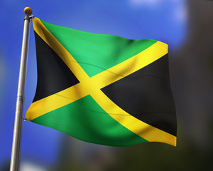 jamaican flag waving in blue sky