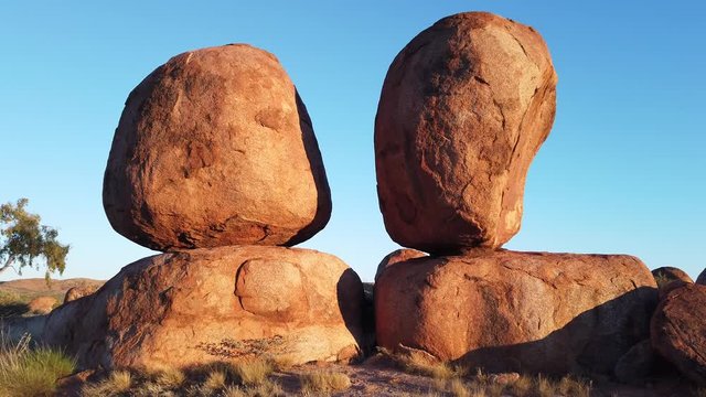 twin rocks in outback landscape at Devils Marbles. The Eggs by sunrise of Karlu Karlu in Northern Territory, Central Australia.