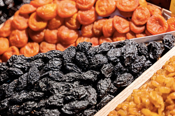 Assorting of dried fruits on market
