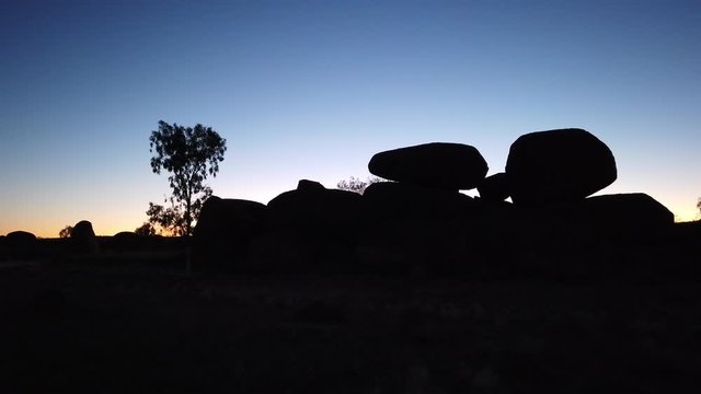 Silhouette of Devils Marbles rock formations by night. Karlu Karlu Devils Marbles Conservation Reserve on the Stuart Highway in Northern Territory near Tennant Creek, Australia.