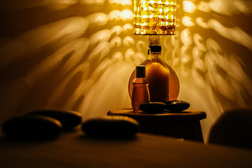 Professional massage relaxation lights and hot stones with coconut oil