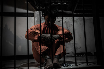 Asian man desperate at the iron prison,prisoner concept,thailand people,Hope to be free,Serious...