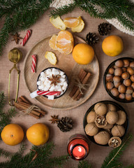 Christmas composition with coffee, tangerines and nuts.
