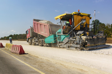 Construction of a new modern highway Tavrida in the Crimea. Backfilling of rubble from the truck...