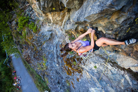 A woman climbs up the sustained roof on the overhung La Vida Locomotive (5.11a) at Exit 38 near Seattle, Washington.
