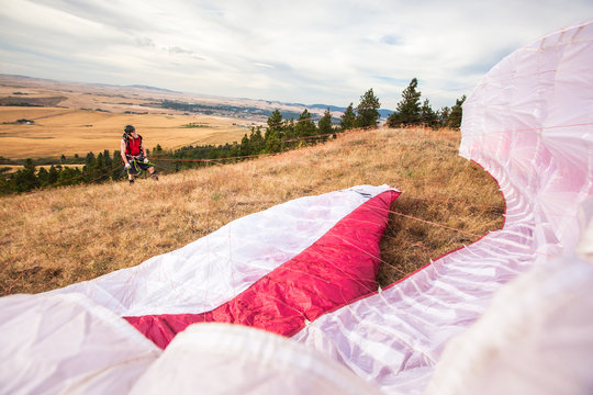 A man waits for the right wind conditions to take off during a paragliding outing with his son near Moscow, Idaho.