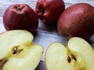  close-up of red ripe juicy organic delicious apples on a wooden tabletop background