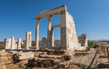 Fototapeta na wymiar Sangri, Naxos / Greece - July 13, 2019: Tourists visting Demeter's temple and ruins at Sangri village, Naxos, Greece