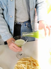 man pouring champagne into glass of champagne