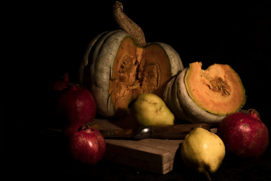 Autumnal Still Life. Pumpkin, quince and pomegranate. Stock photo