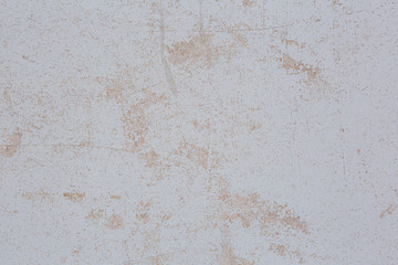 Abstract background in the form of a white painted surface with peeling paint.