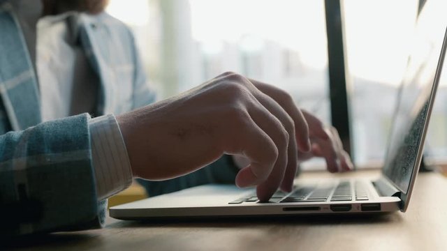 hands typing on computer keyboard, moving camera, business man working on laptop pc in office.