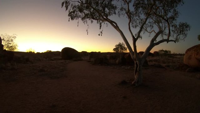 Australian outback landscape of Devils Marbles rock formations after twilight. Bush vegetation of Karlu Karlu Devils Marbles Conservation Reserve at dusk in Northern Territory, Australia.