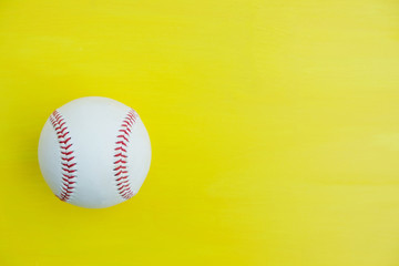 Baseball ball isolated on yellow background for sport concept with copy space.
