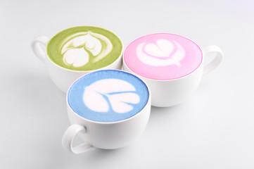 Three matcha tea cups at white background. Green, pink and blue matcha. Detox drink concept. Natural beverages