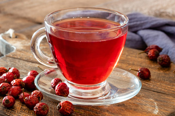 A cup of rose hip tea with dried rose hips