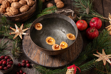 Candles made from nutshells floating in a bowl of water - old Christmas custom