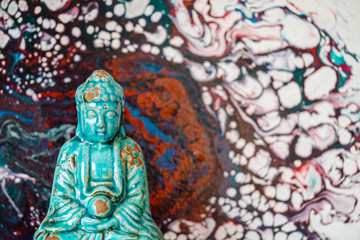 Fototapeta premium Buddha figurine on abstract pattern background