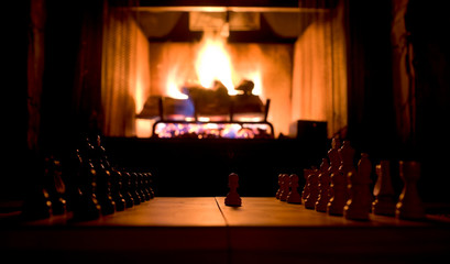 Chess Board and Pieces with Fireplace in Background