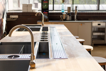 Mixer water tap and sink in modern kitchen interior.