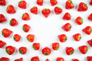 Strawberry on white background, top view. Berries pattern. Heart frame made of fresh strawberry on white background. Creative food, valentine, romantic concept. Copy space, flat lay