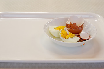tokyo, japan, 11/17/2019 , broken boiled egg with its shell on a plate