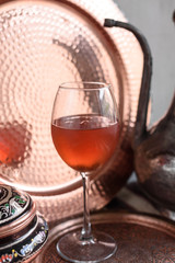 Iced Rosehip Drink. Copper Metal Background.