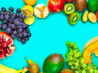 Fruits and vegetables rich in antioxidants, vitamin and fiber on blue background. Flat lay style