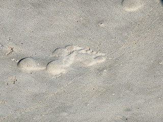 Fototapeta na wymiar Footprints in sand. Close up.