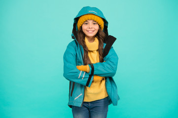Properly equipped. Ski resort concept. Winter collection. Child wear hat and jacket. Active leisure. Sporty style. Girl enjoy winter season. Winter vacation. Protective clothes. Happy smiling kid