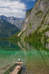 lake Obersee with boat and view at alps
