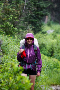 Female Backpacker With A Rain Jacket On Hiking In The Rain In Grand Teton National Park.