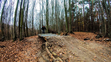 Amateur rider on the bicycle in the autumn park