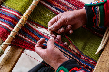 Weaving woman, hand-made colorful materials. Chinchero, Peru.