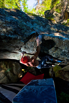 A man ignoring physics on  The Rabbit Hole (V11), a horizontal roof problem at Yankee Jim.