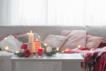 Christmas decora with candles and balls on white table indoor