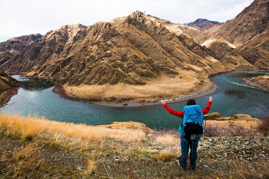 A woman gestures at the size of a bend in the Snake River at Hells Canyon in Idaho.