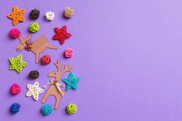 New Year decorations on purple background. Festive stars and balls. Merry Christmas concept with empty space for your design
