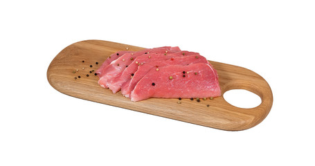 pieces of fresh pork meat with pepper on a wooden cutting Board isolate on a white background