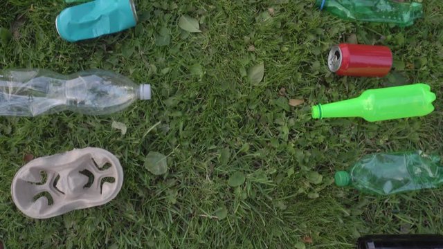 girl collects plastic bottles in a trash bag