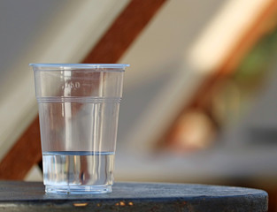 transparent plastic cup of water on table with copy space