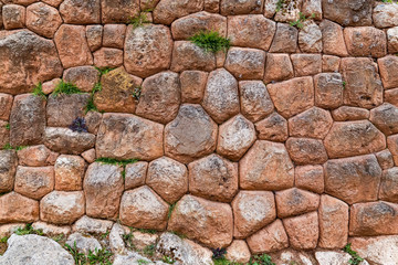 A stone wall in the Inca ruins. Chinchero, Peru.