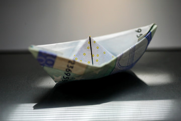 Paper boat made with Euro bills.